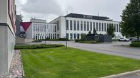 Isoja oppilaitoksen rakennuksia. Niiden edessä nurmikkoa, puita ja parkkipaikkoja.