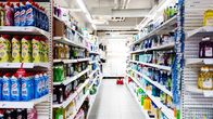 Brightly lit department store aisle shelves filled with cleaning products.