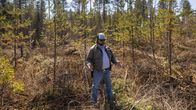 Mies seisoo metsässä.