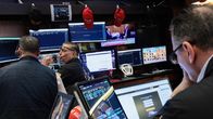Välittäjiä New Yorkin pörssissä tietokoneiden monitoreiden äärellä.