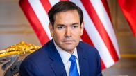 Marco Rubio sininen puku yllään, taustalla Amerikan lippu.