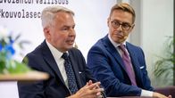 Pekka Haavisto and Alexander Stubb sitting next to each other, Haavisto speaking to an audience.