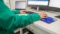 Anonyymihenkikö tekee töitä tietokoneella Visma solutionsin toimistossa.