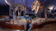 Yleisradion toimittaja Johannes Blom Helsingin Luonnontieteellisessä museossa, kädessään Dougal Dixonin klassinen tietokirja "Ihmisten jälkeen".