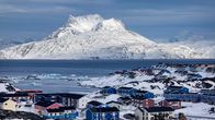 Vy över Grönlands huvudstad Nuuk, i förgrunden syns färgglada hus medan det snötäckta berget Sermitsiaq syns i bakgrunden. 
