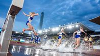 Photo shows runners on a track.
