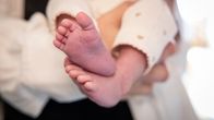 Photo shows a baby's feet.