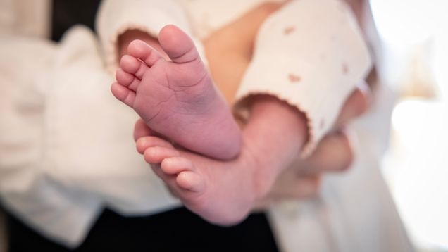 Photo shows a baby's feet.