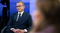 Petteri Orpo istuu A-studiossa tummassa puvussa.
