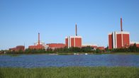 Large red buildings of the Olkiluoto nuclear power plant on the seashore in Eurajoki.