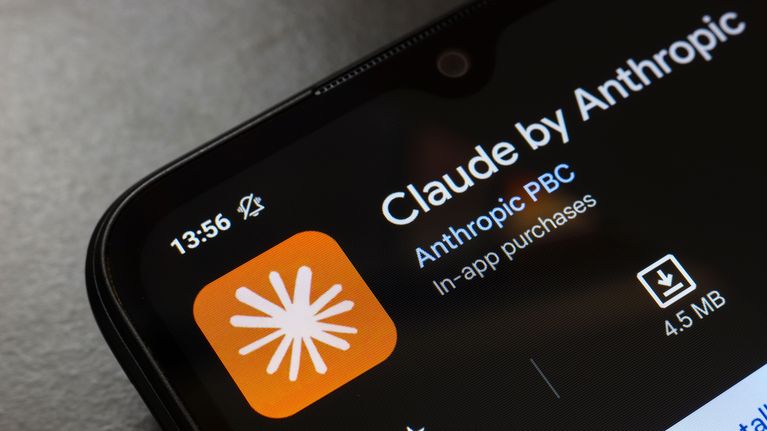 A smartphone screen displays Claude's logo.
