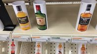 Photo shows cardboard displays of alcohol products.