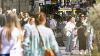 People walking on the street on a sunny day.