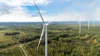 Wind turbines in the middle of a forest.
