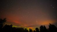 Photo shows a meteor shower and the northern lights.