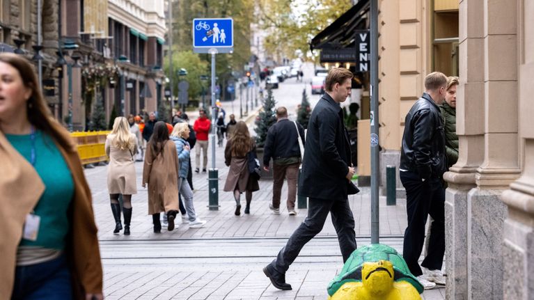 People dressed for autumn walking in central Helsinki.