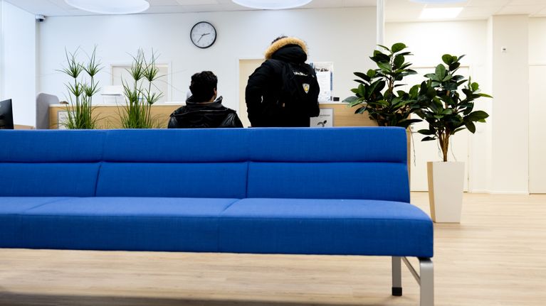 Photo shows two people in an employment office.