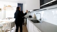 Two people inspecting a kitchen at an apartment viewing. 