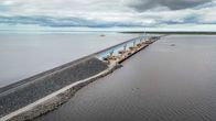 Aerial view of a road over a long causeway and bridge.