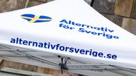 Valkoisessa teltassa on Ruotsin lipun värein varustettu sydän ja tekstit "Alternativ för Sverige" sekä "alternativforsverige.se".