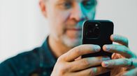 Man looking at mobile phone.
