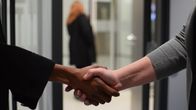 Close-up of two people shaking hands.