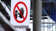 Rakennustyömaan pääsy kielletty -kyltti metalliaidassa.