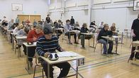 Ylioppilaskirjoitusten osallistujia liikuntasalissa.