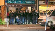 Mellakkapoliisi jututti miesjoukkiota Hägerstenin kaupunginosassa Tukholmassa varhain toukokuun 25. päivän aamuna. 