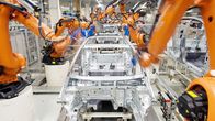 Robotit kasaavat autoja Volkswagenin tehtaan liukuhihnalla Saksan Wolfsburgissa.
