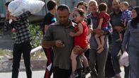 Palestiinalaiset pakenivat kodeistaan Gazassa Israelin iskujen seurauksena 13. heinäkuuta 2014.