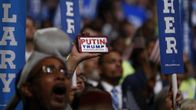 Kuva ihmismassasta Philadelphian puoluekokouksessa. Väkijoukon keskellä joku pitää esillä kännykkää, jonka näytöllä lukee: "Putin. Trump. Making Russia Great Again."