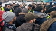 Demonstrating Iraqi asylum seekers listen to details about a meeting with Immigration Service officials at Helsinki Railway Square on Monday February 27, 2017.