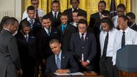 US President Barack Obama, surrounded by students from a Chicago youth guidance program called Becoming A Man, signs a Presidential Memorandum, called the My Brother's Keeper Task Force, in the East Room of the White House in Washington, DC, USA, 27 Febru