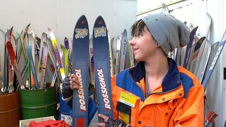 Rebekka esittelee käytettyjä suksia Oulun kierrätyskeskuksen myymälässä.
