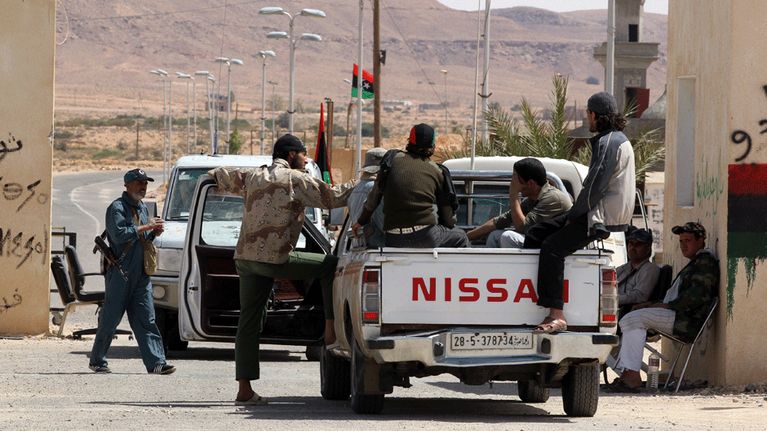 Libyalaiskapinallisia auton kyydissä Wazinin raja-asemalla.