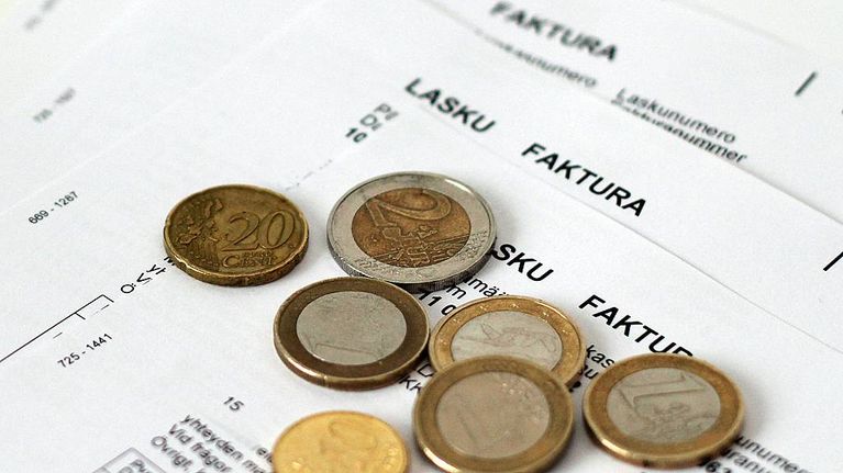 Kuvassa laskuja ja muutamia euroja.