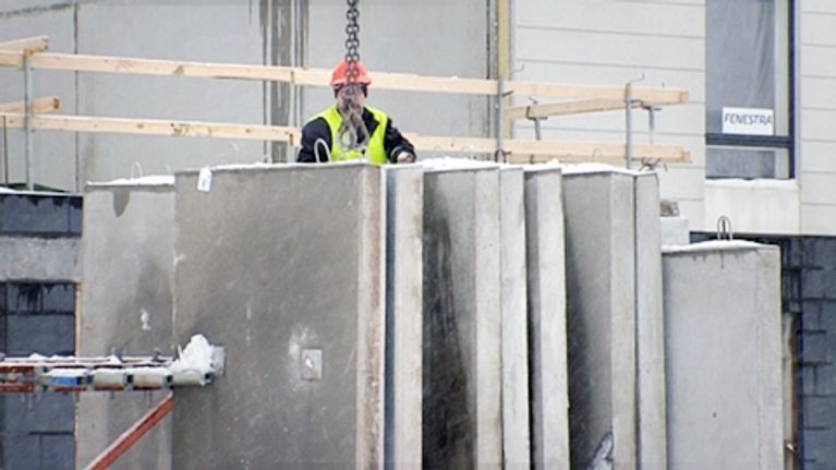 Rakennusmies työskentelee rakennustyömaalla.