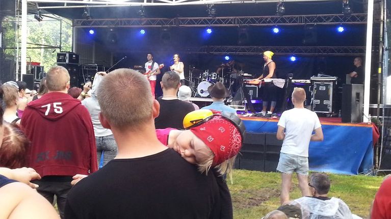 Lapsi nukkuu isänsä olkapäällä KarmaRock-festivaalilla