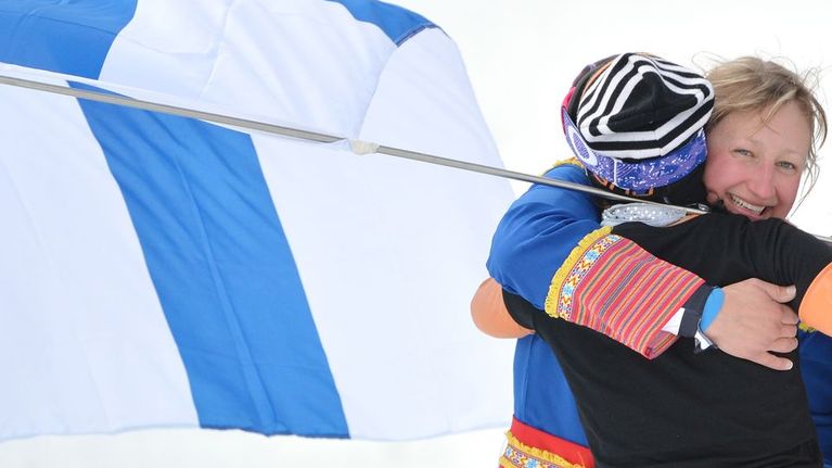 Tanja Poutiainen Suomen lipun kanssa.