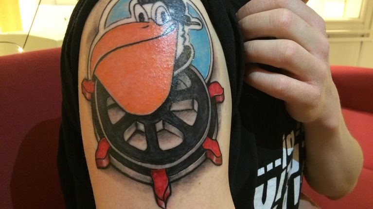Pelicans- ja Lahti-aiheinen tatuointi olkapäässä.