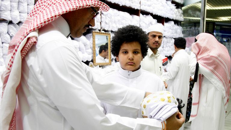 Saudimies ostaa vaatteita lapselleen Riadissa.